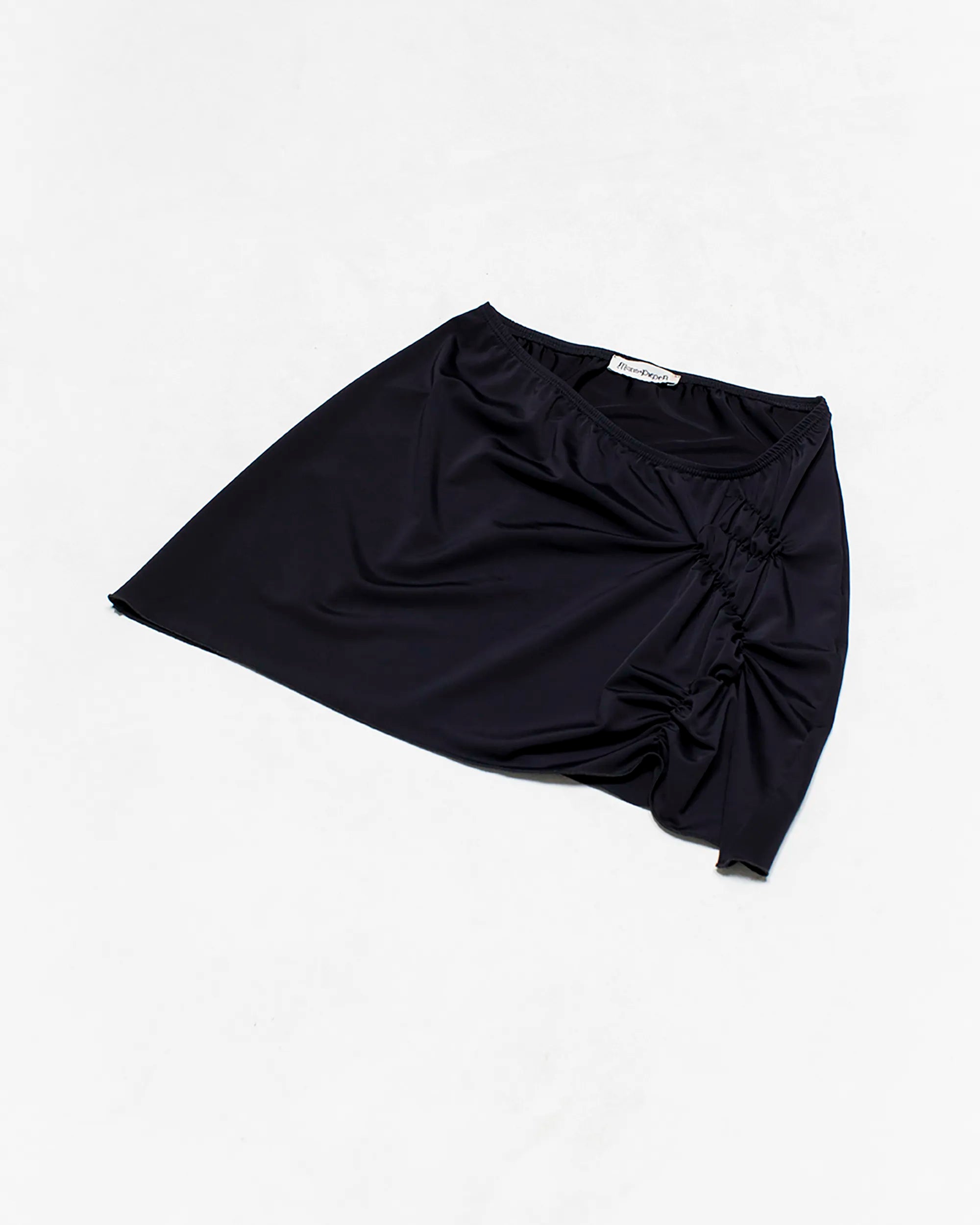 black mini skirt with ruching detail on the front side