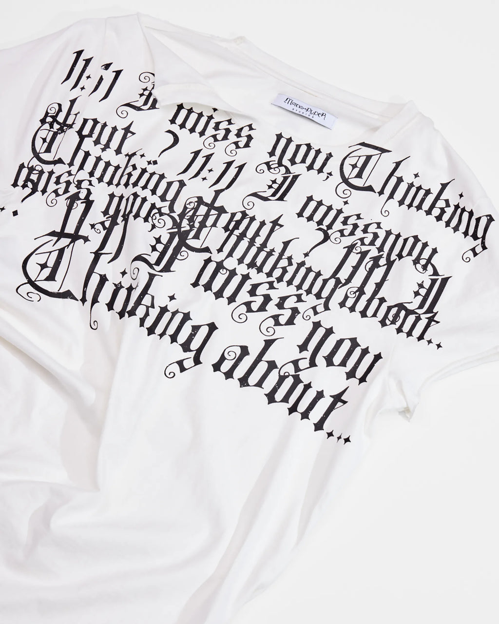 print detail of distressed white t-shirt with ruching on side