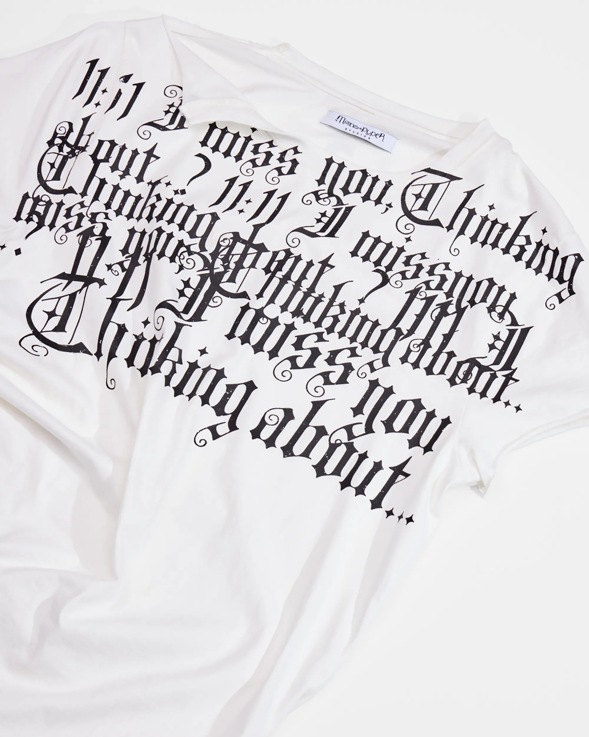print detail of distressed white t-shirt with ruching on side