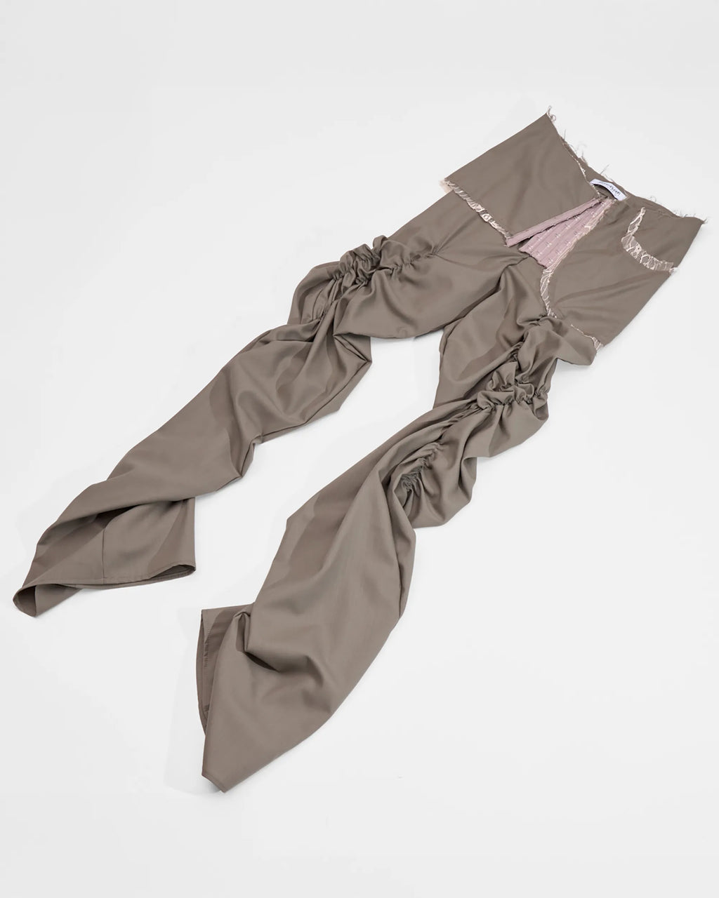 taupe wool trousers with ruched legs, lace detail and corset closure
