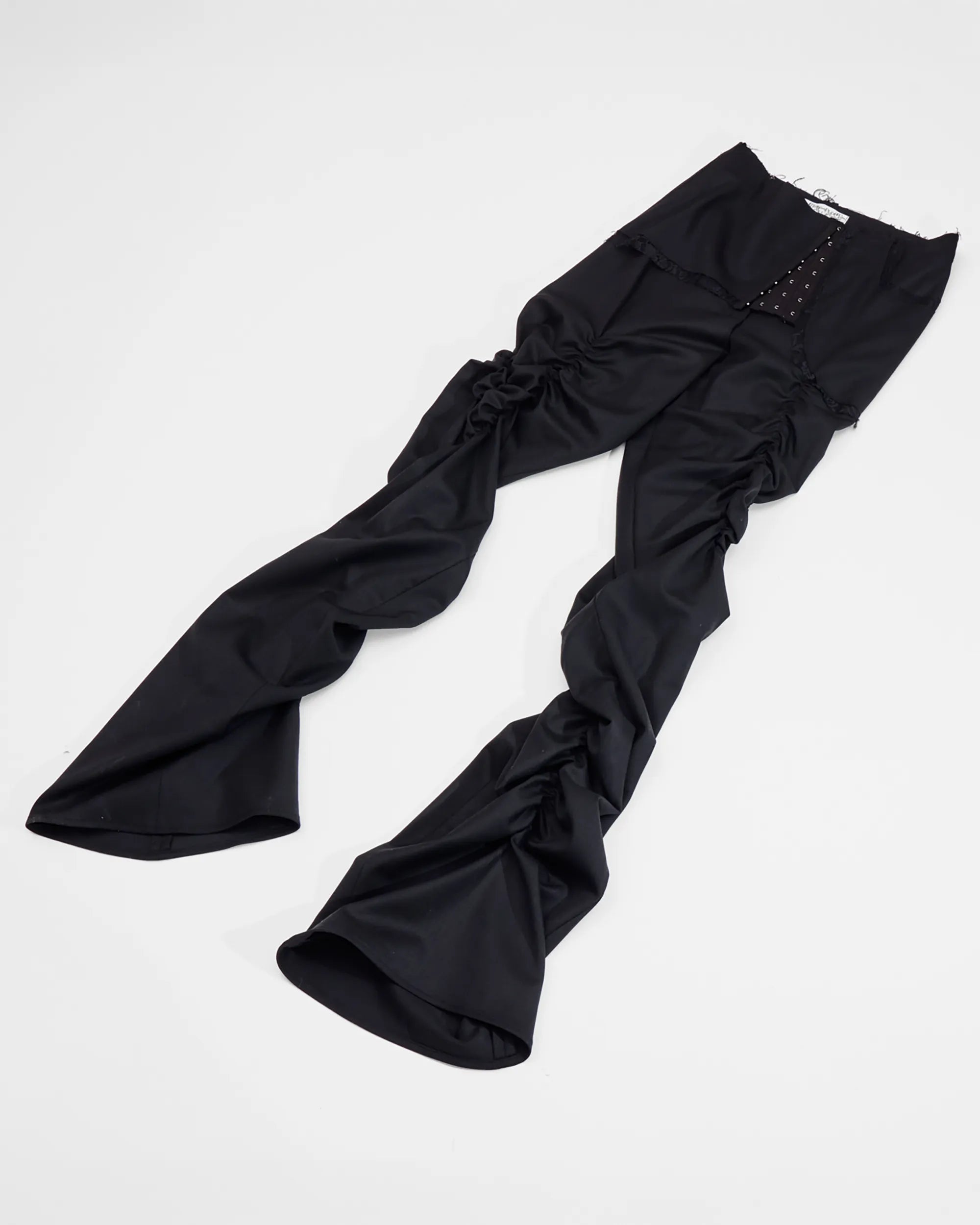 black wool trousers with ruched legs, lace detail and corset closure