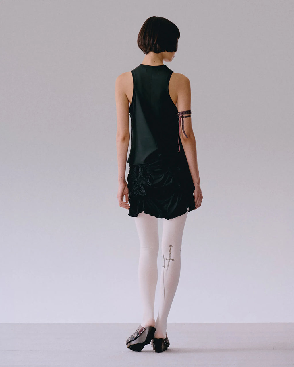 Back view of black top with shirring detail