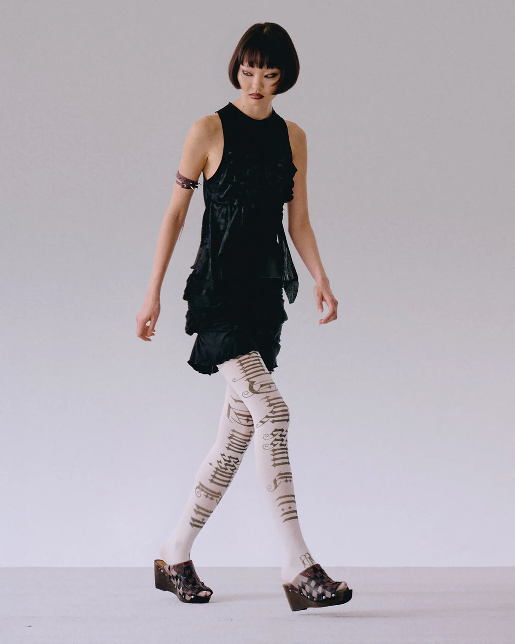 Side view of black top with ruching detail on body